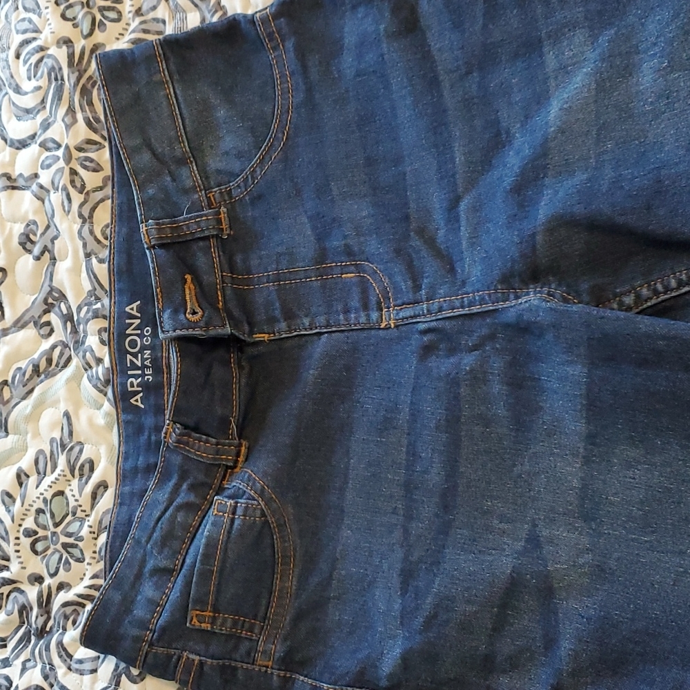 Arizona jeans with distressed bottoms.